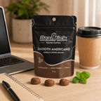 BeanKick smooth Americano coffee package on a desk with a laptop and coffee cup.
