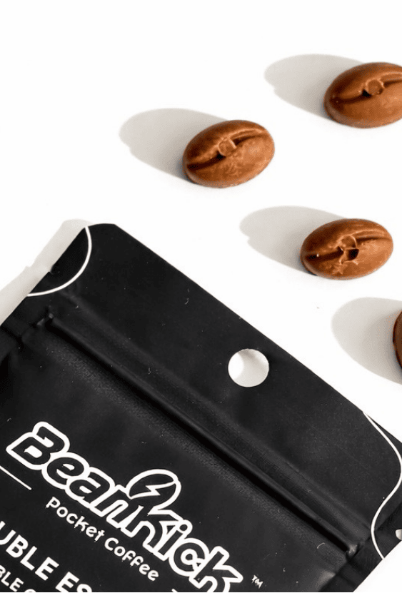 Black coffee pouch with 'BeanKick Coffee' branding and coffee beans on a white background